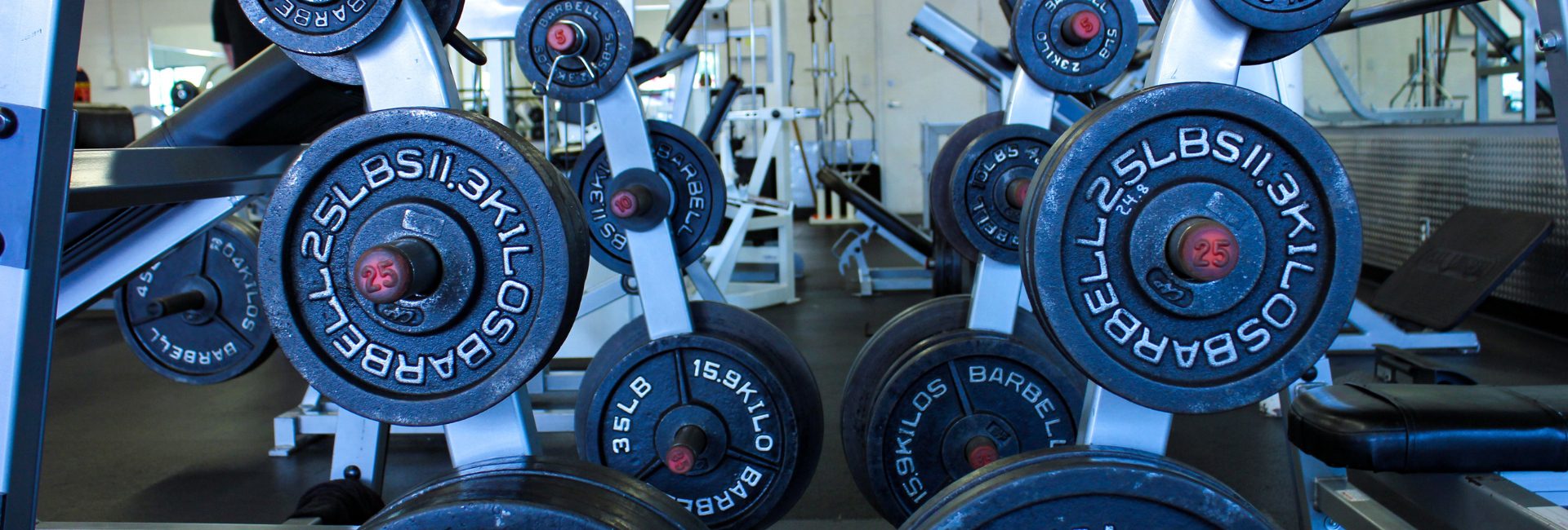 weight plates on a functional fitness and strength training machine in a modern gym Albuquerque NE Heights