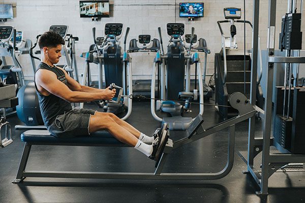 man using best workout machine in a modern gym